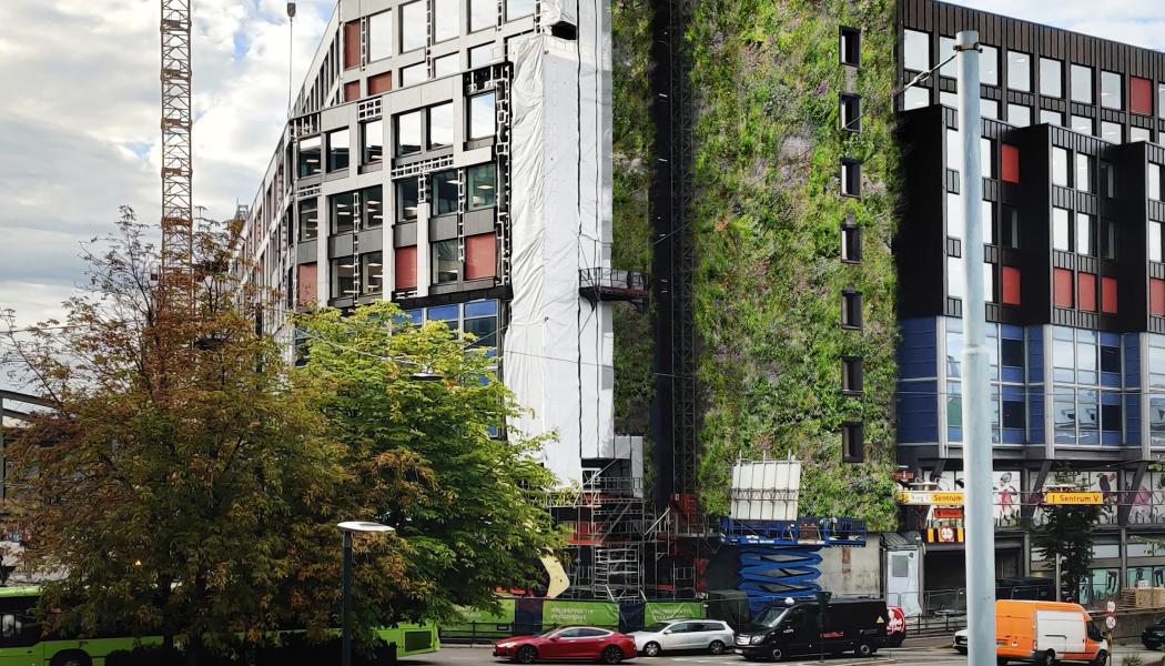 Vy som möter besökare som kommer in till Oslo med tåg. Det 35 meter höga trapphuset med Europas högsta växtvägg.