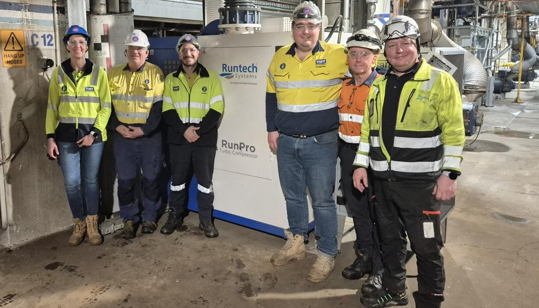 Visy and Runtech teams photographed next to a RunPro Turbo Compressor. From the left: Alessandra Bandeira, Michael Coleman, Leonardo Bau, Cameron Heins, Bruce MacGregor and Mika Tähtinen. Photo: Runtech